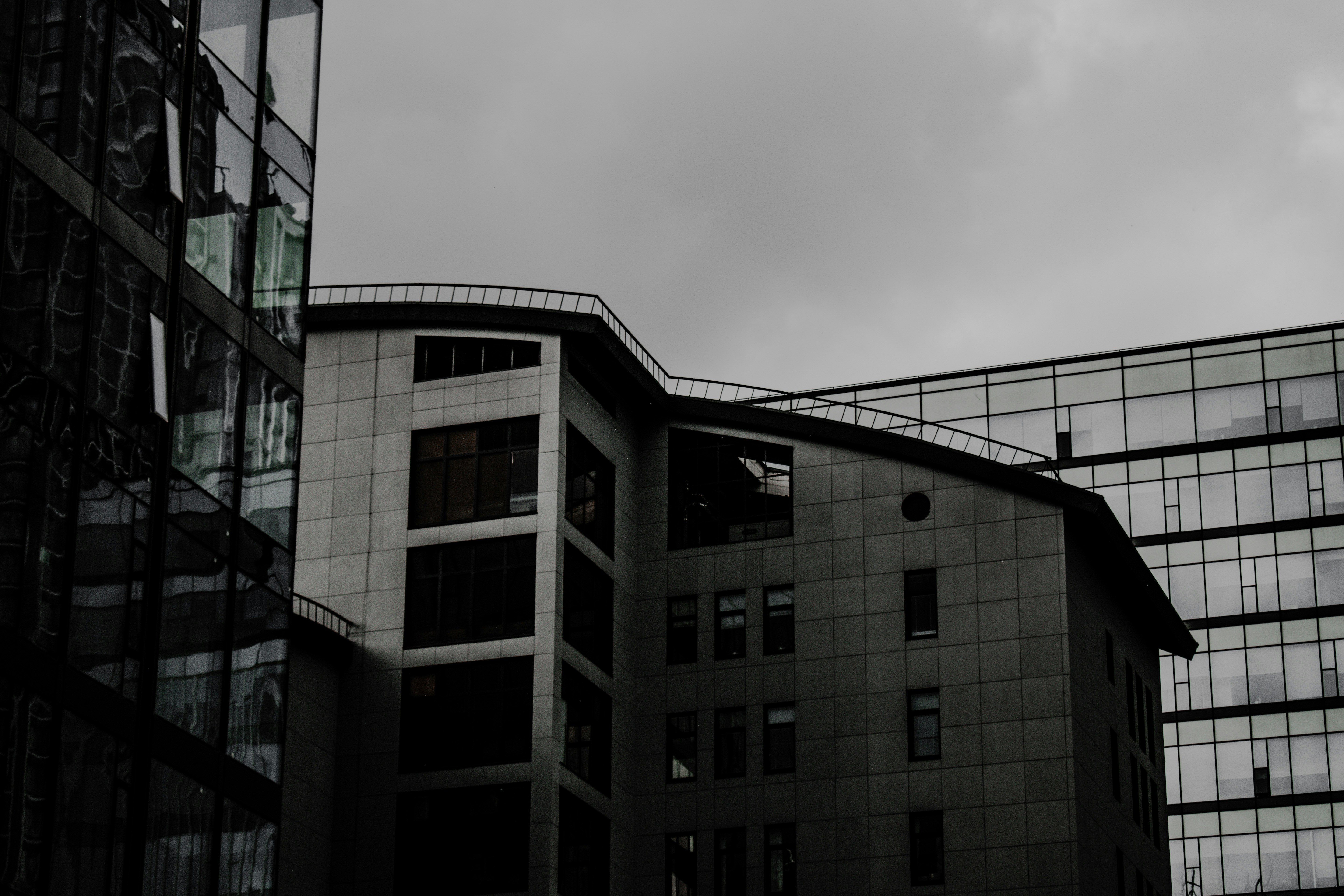 black and white concrete building under gray sky